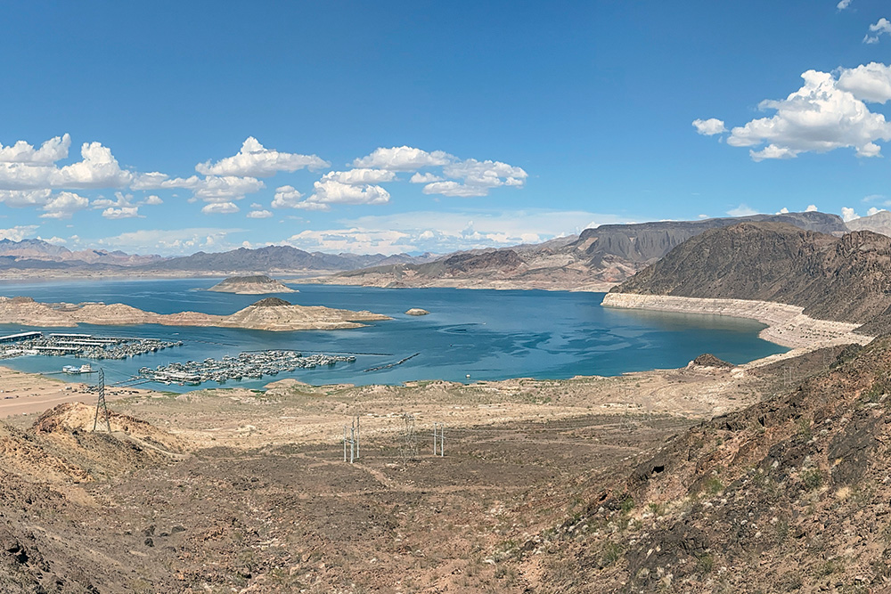A photo of Lake Mead shows a ring of lighter soil around the lake, marking the higher volume where the water level once reached.