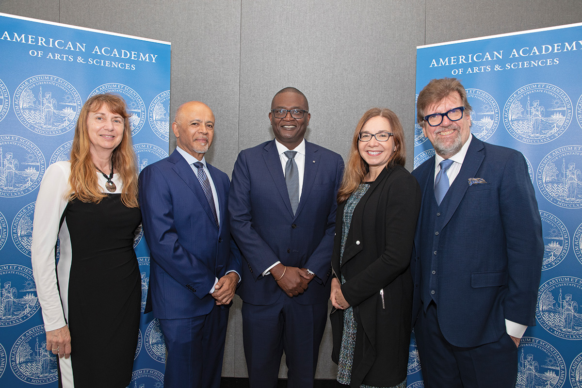 Maja Matarić, Abraham Verghese, Kerwin Charles, Katharine Hayhoe, and Oskar Eustis stand together at the Induction ceremony for the 2022 and 2023 class of inductees to the Academy.