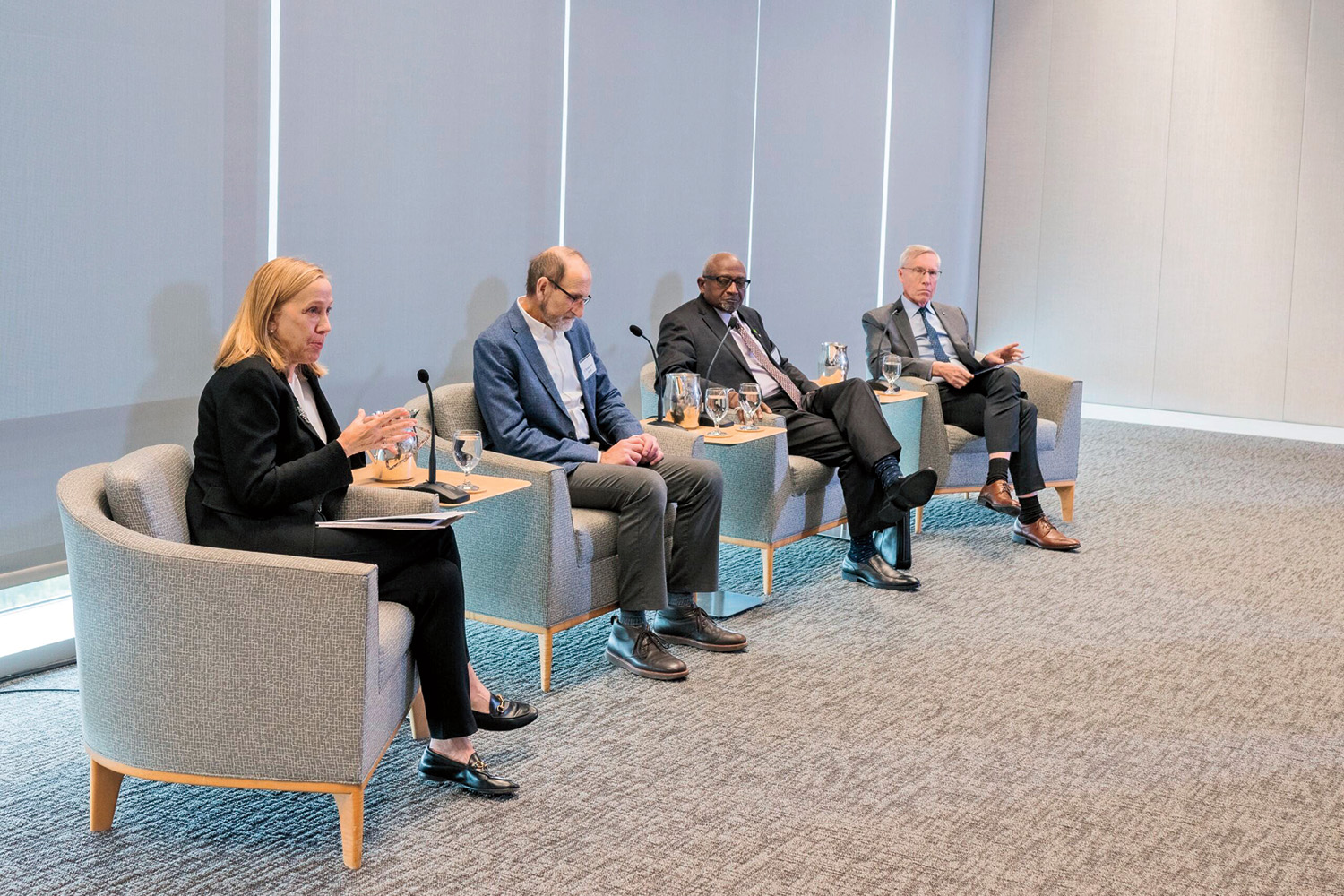 Patricia Vincent-Collawn, Christopher Field, Robert Bullard, and David Oxtoby, seated in chairs next to one another, address an audience not pictured.