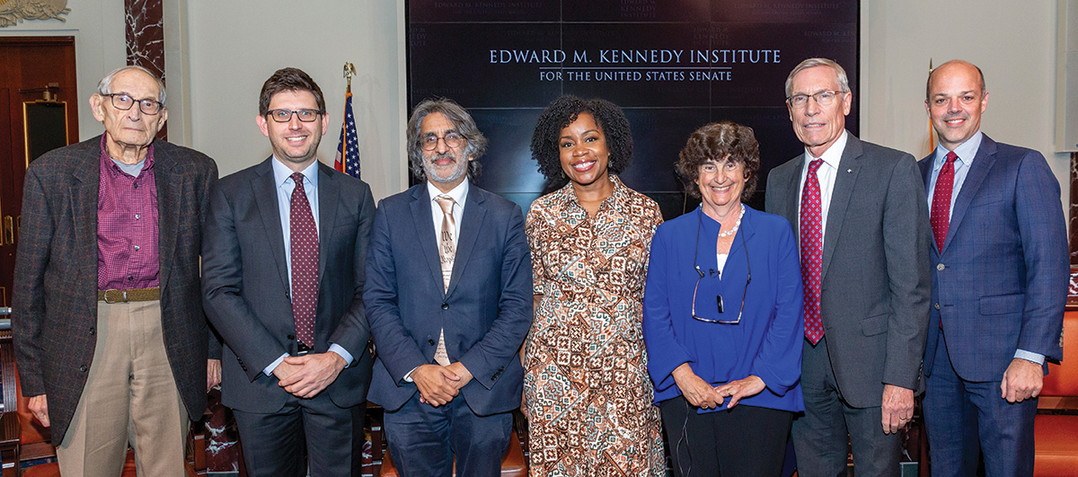 Four attendees stand beside the speakers from the event at the Edward M. Kennedy Institute for the United States Senate held to promote the Case for Supreme Court Term Limits report.