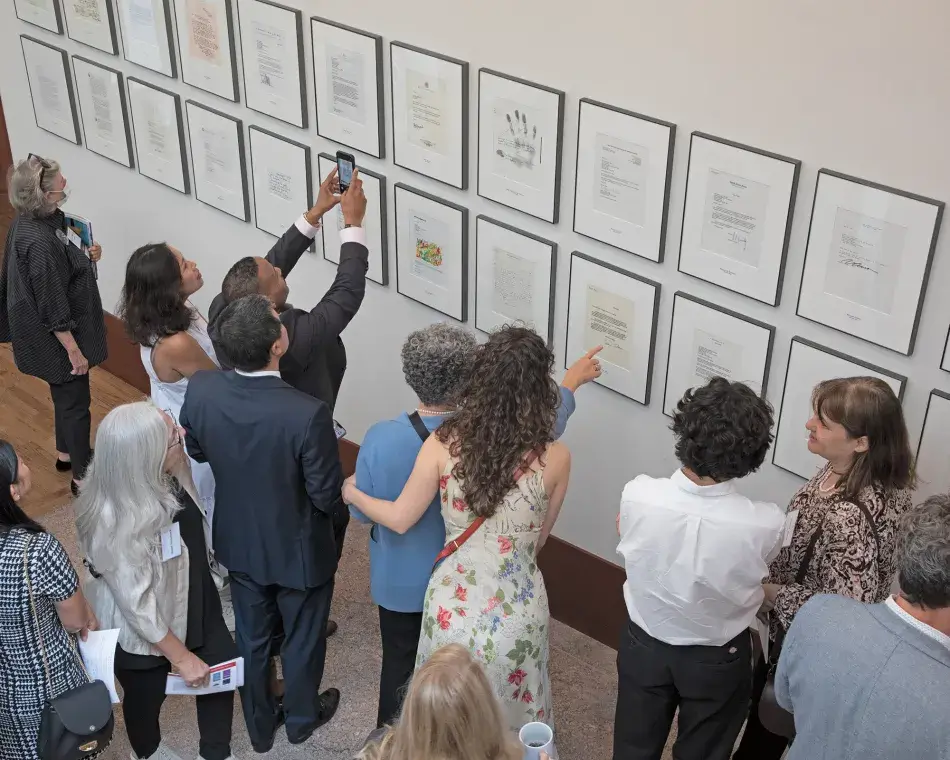 People at the Academy for the open house looking at letters of acceptance. 