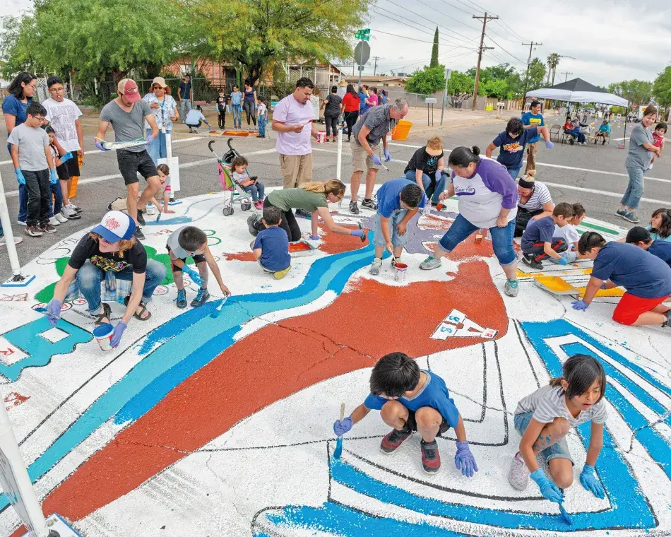 Children painting on the ground. Photo by Vanessa Grossl.