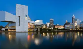 Skyline of Cleveland at dusk with the Rock and Roll Hall of Fame.