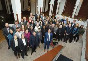 Large group of people standing for photo after participating at Making Justice Accessible Summit.