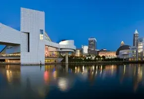 Skyline of Cleveland at dusk with the Rock and Roll Hall of Fame.